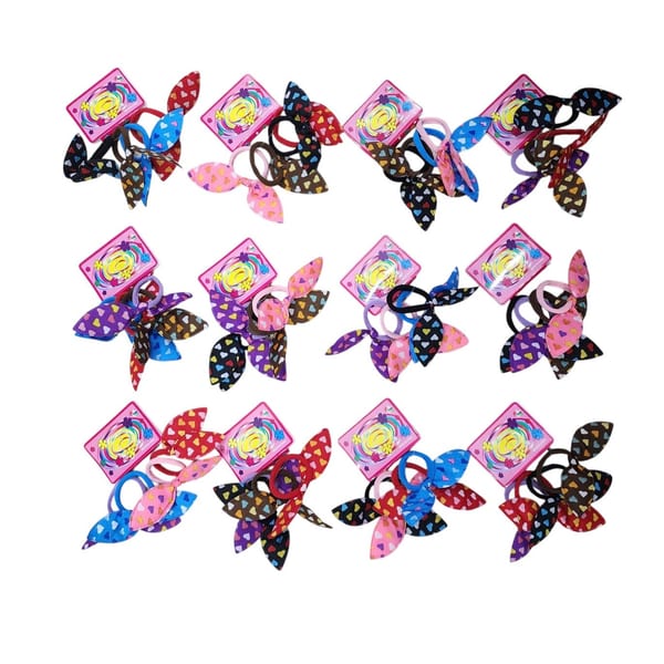Tarjetas exhibidoras con colitas para el pelo de tela estampadas con corazones multicolores