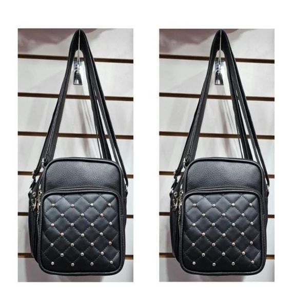 Bandolera negra con bolsillo frontal matelassé y tachas plateadas