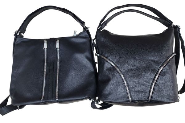 Dos carteras negras de símil cuero con cierres metálicos plateados en el frente