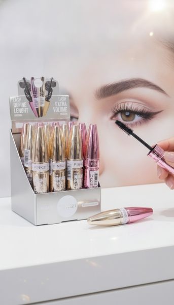 Caja exhibidora de máscaras de pestañas marca Pink 21 en envases metálicos rosados y dorados