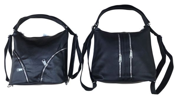 Dos mochilas carteras de color negro con cierres metálicos sobre un piso de baldosas.