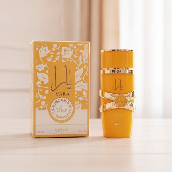 Perfume Lattafa Yara Tous de 100 ml en frasco amarillo con caja decorada