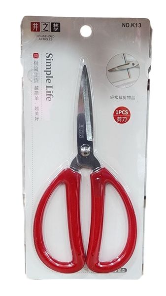 Tijera multiuso de acero con mango rojo dentro de un blíster transparente de presentación.